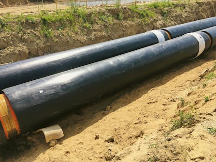 New,Insulated,Water,Pipes,In,The,Trench,Construction,Site,.